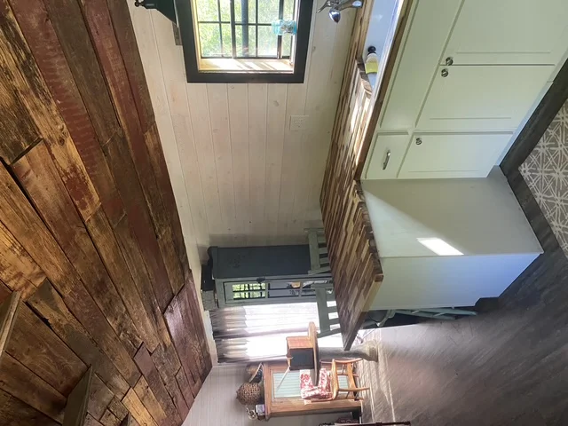 Renovated entryway with white shiplap ceiling, hardwood floors, and new window