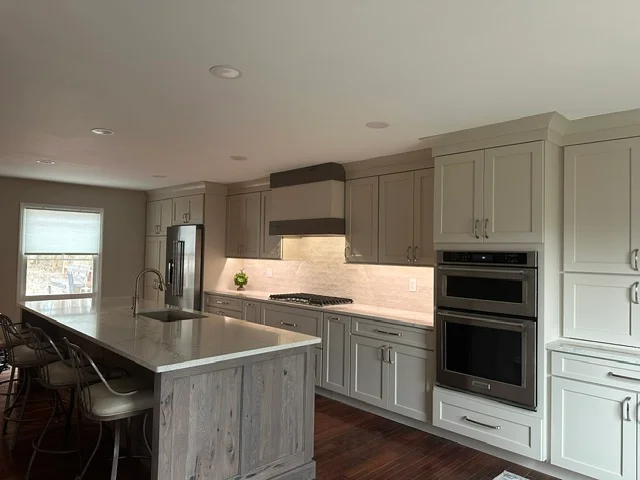 Modern kitchen with gray cabinetry, quartz counters, and stainless steel appliances
