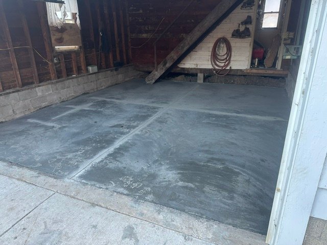 Newly poured concrete garage floor with smooth finish and clean edges